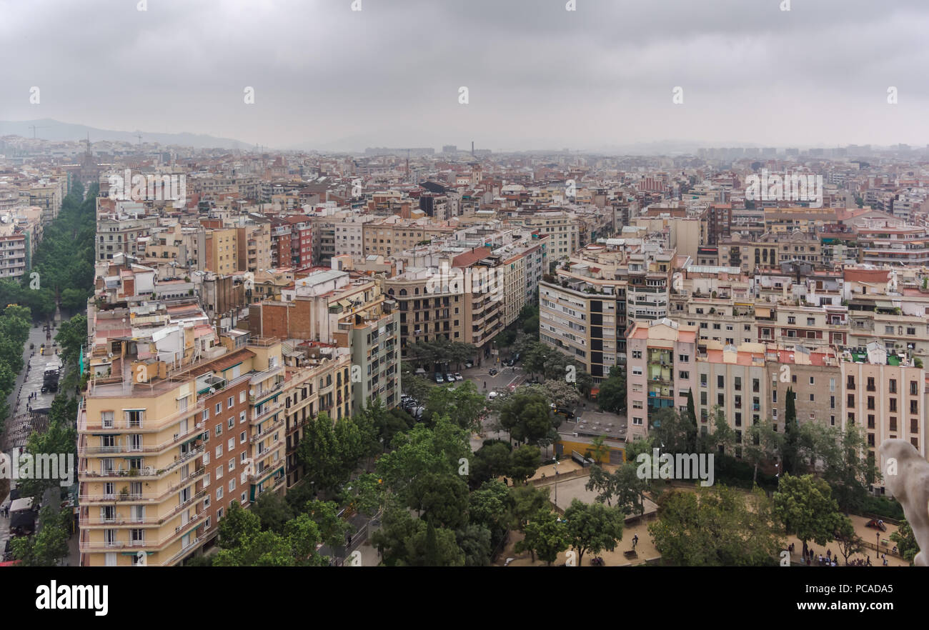 View to Barcelona city from the top of Sagrada Familia in a dull, murky day with a very grey and overcast sky. Barcelona skyline under heavy clouds Stock Photo