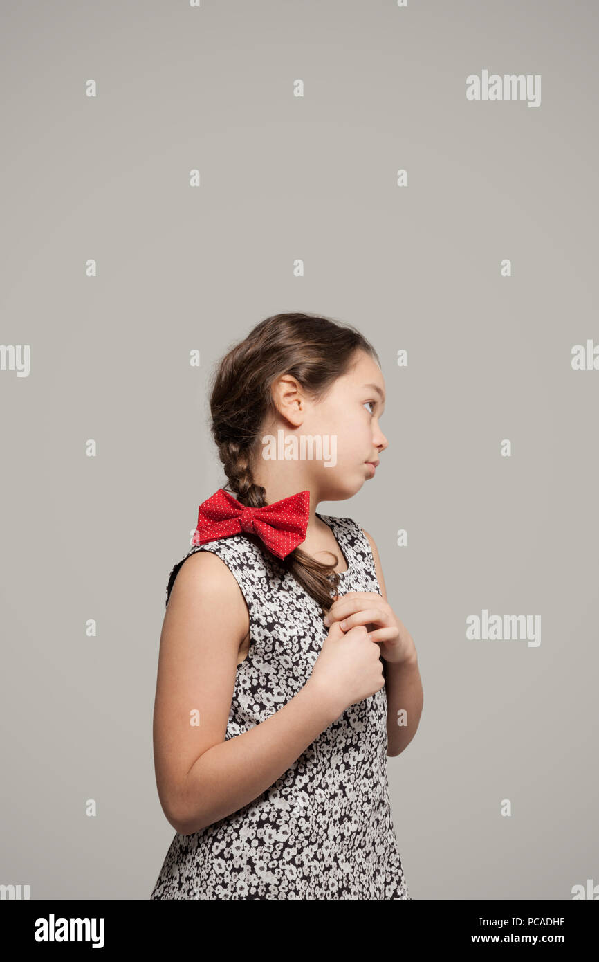 Little girl with red bow in her hair wearing a dress Stock Photo - Alamy