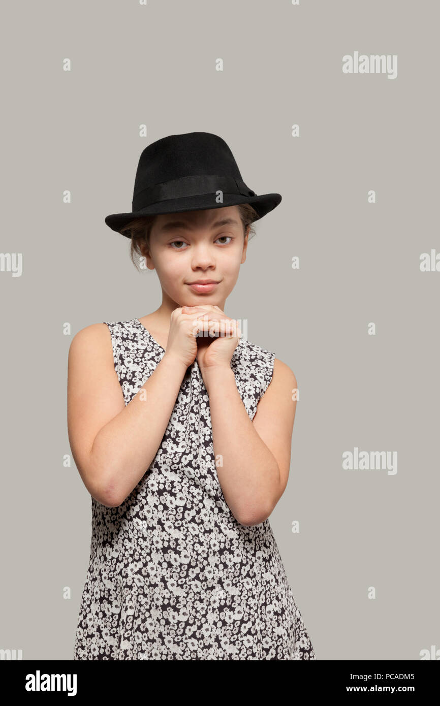 Sweet girl with black hat wearing a dress, portrait Stock Photo - Alamy