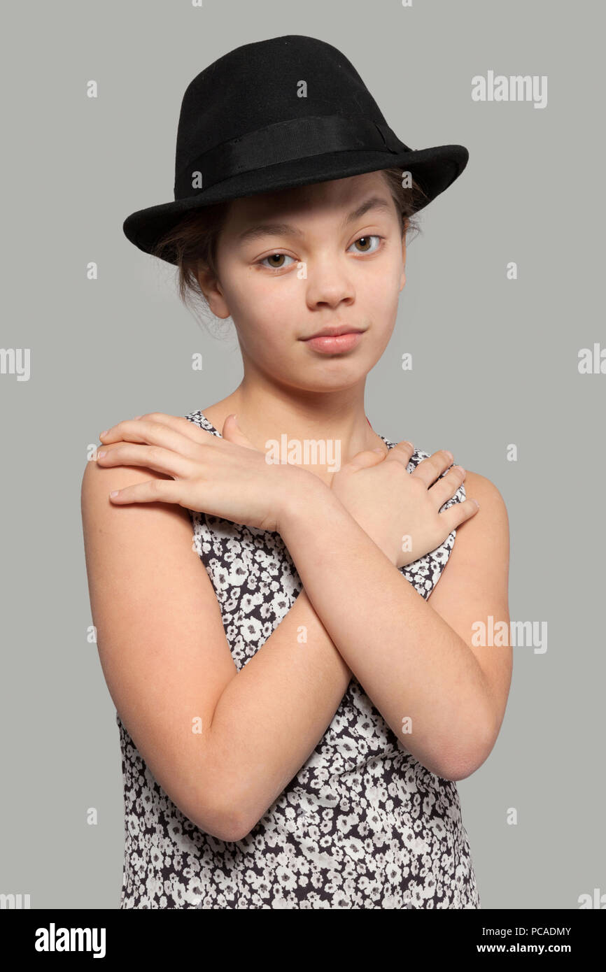 Sweet girl with black hat wearing a dress, portrait Stock Photo - Alamy