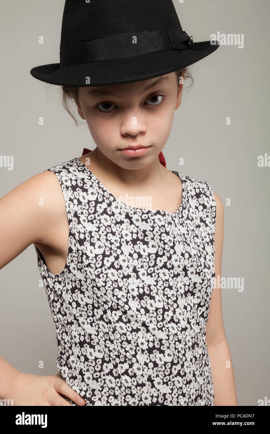 Little girl with black hat wearing a dress, portrait Stock Photo - Alamy