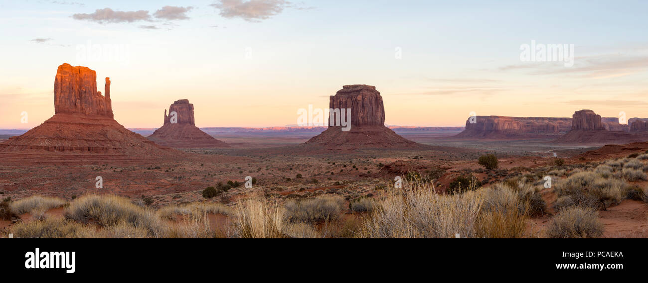 The giant sandstone buttes glowing pink at sunset in Monument Valley Navajo Tribal Park on the Arizona-Utah border, USA, North America Stock Photo