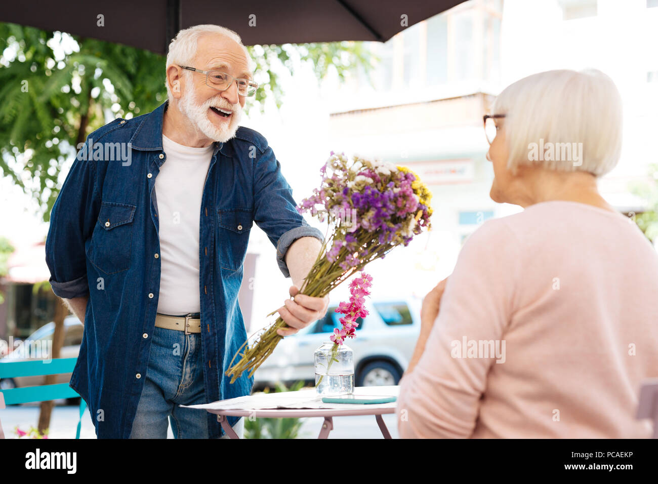 Jolly senior man surprising wife Stock Photo - Alamy