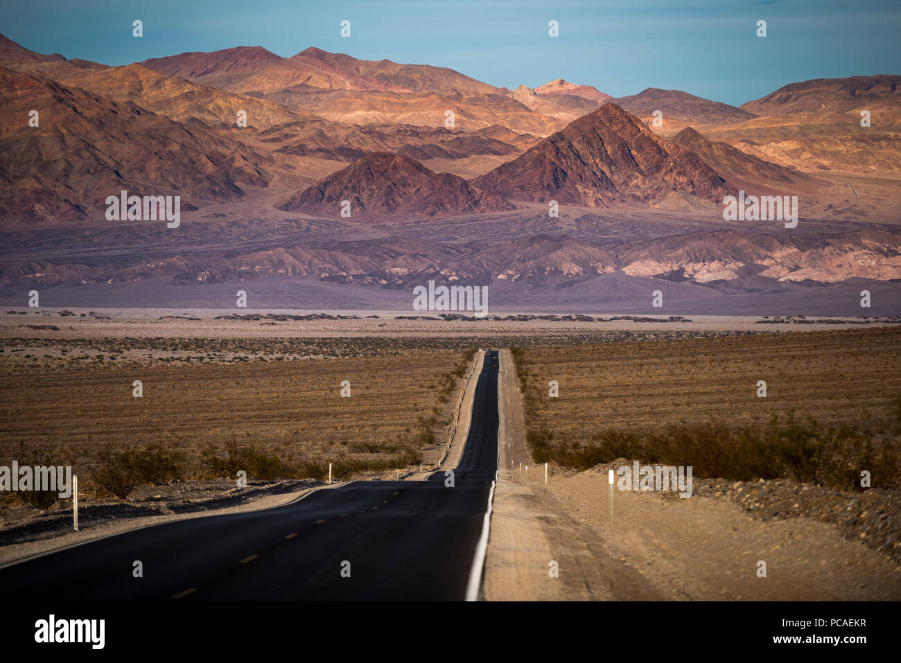 Highway through Death Valley with mountains in the distance, California, United States of America, North America Stock Photo
