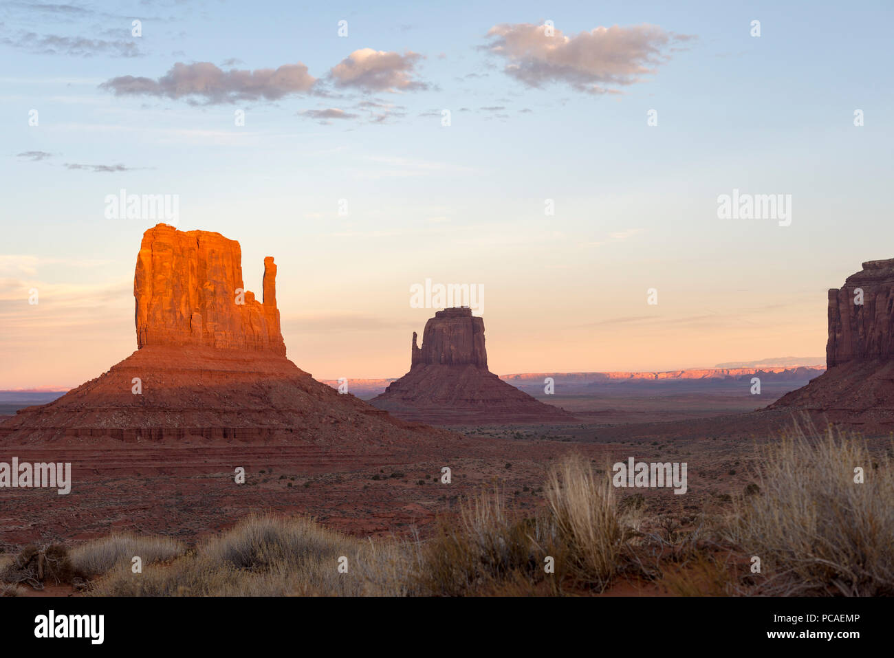 The giant sandstone buttes glowing pink at sunset in Monument Valley Navajo Tribal Park on the Arizona-Utah border, USA, North America Stock Photo