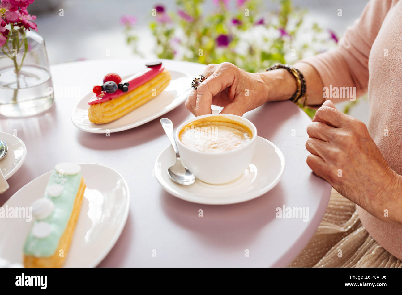 Mature female hands seizing coffee Stock Photo - Alamy