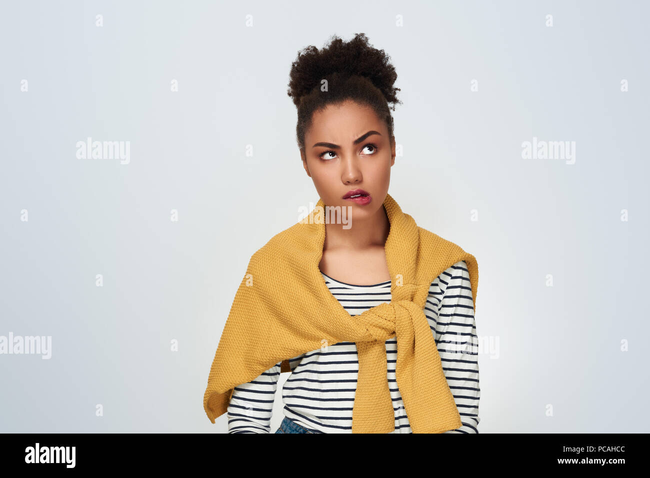 Young woman studio isolated in white biting lip concerned Stock Photo