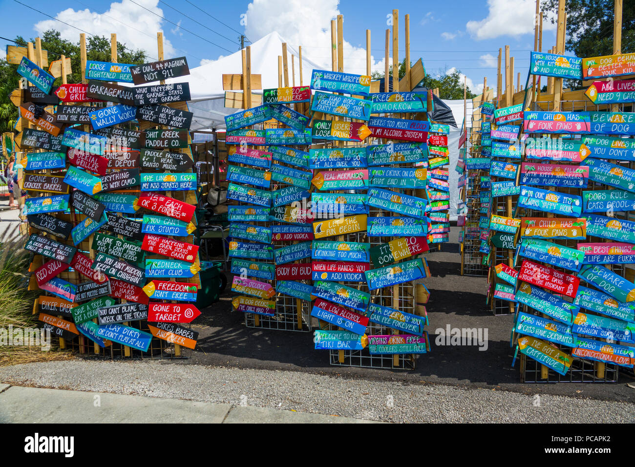 Display of colorful signs of many different sayings at a flea market Stock Photo