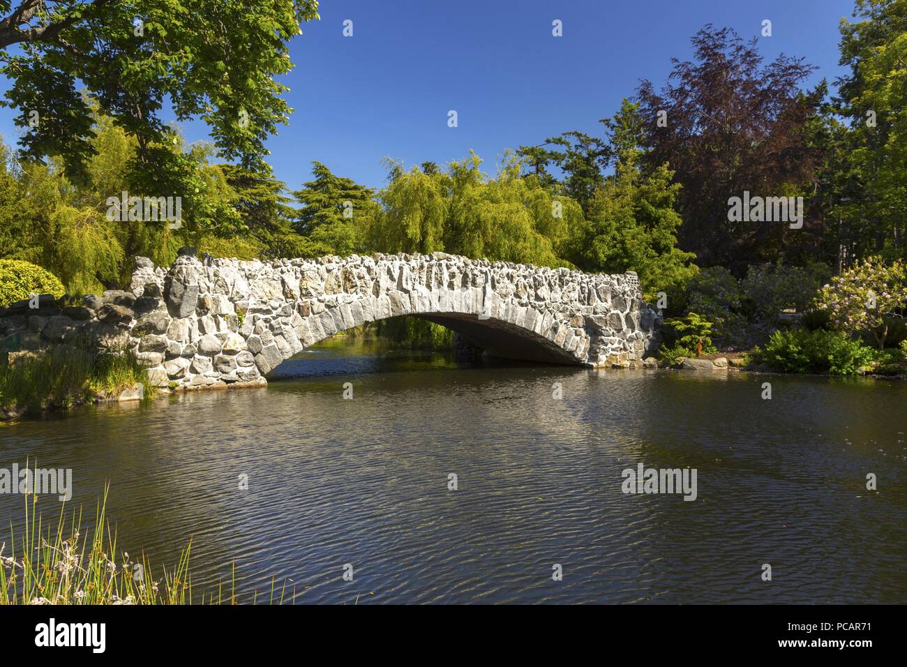 White Stone Pedestrian Bridge over Lagoon in Beacon Hill Urban Park. Nature Landscape near James Bay, Victoria BC Vancouver Island Canada Stock Photo