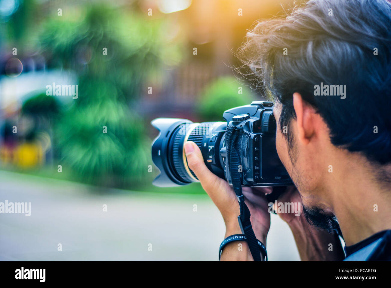 Man using camera DSLR taking photo sunlight background Stock Photo ...