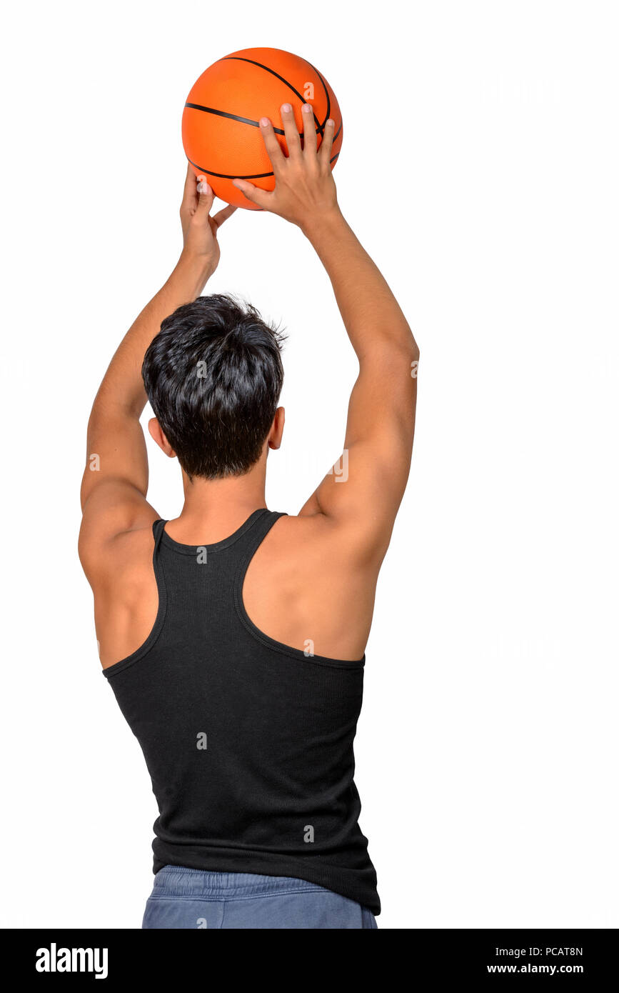 Portrait of a young basketball player passing the ball. Young caucasian boy in sportswear playing basketball on white background with copyspace Stock Photo