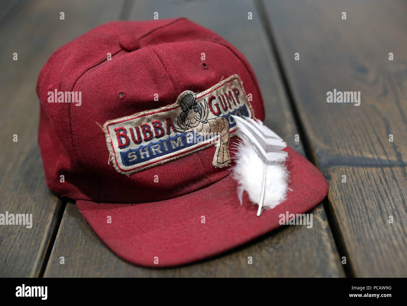 A Bubba Gump cap worn by Tom Hanks in the film Forrest Gump (estimate  £5-7000) alongside a feather from the same film (estimate £5-7000) in the  Prop Store head office near Rickmansworth