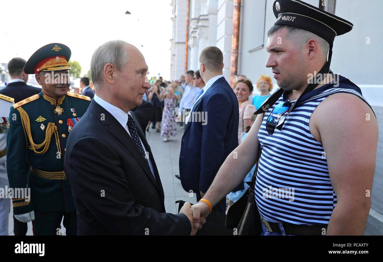 Russian President Vladimir Putin, left, greets a veteran during Navy Day celebrations July 29, 2018 in St Petersburg, Russia. Stock Photo