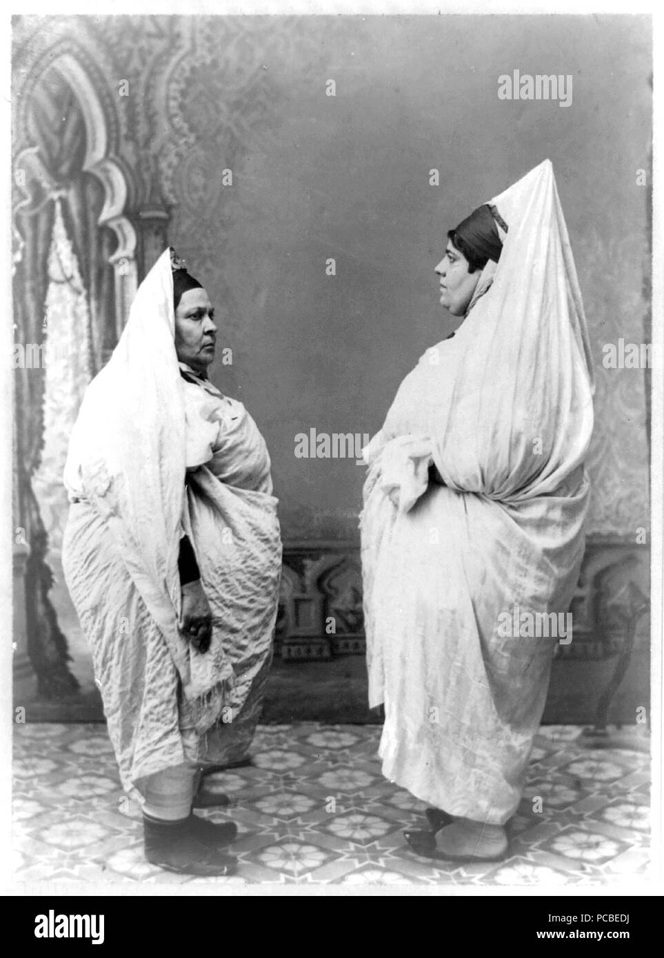 Two Jewish women standing, facing each other, in Tunisia 1900-1923 Stock Photo