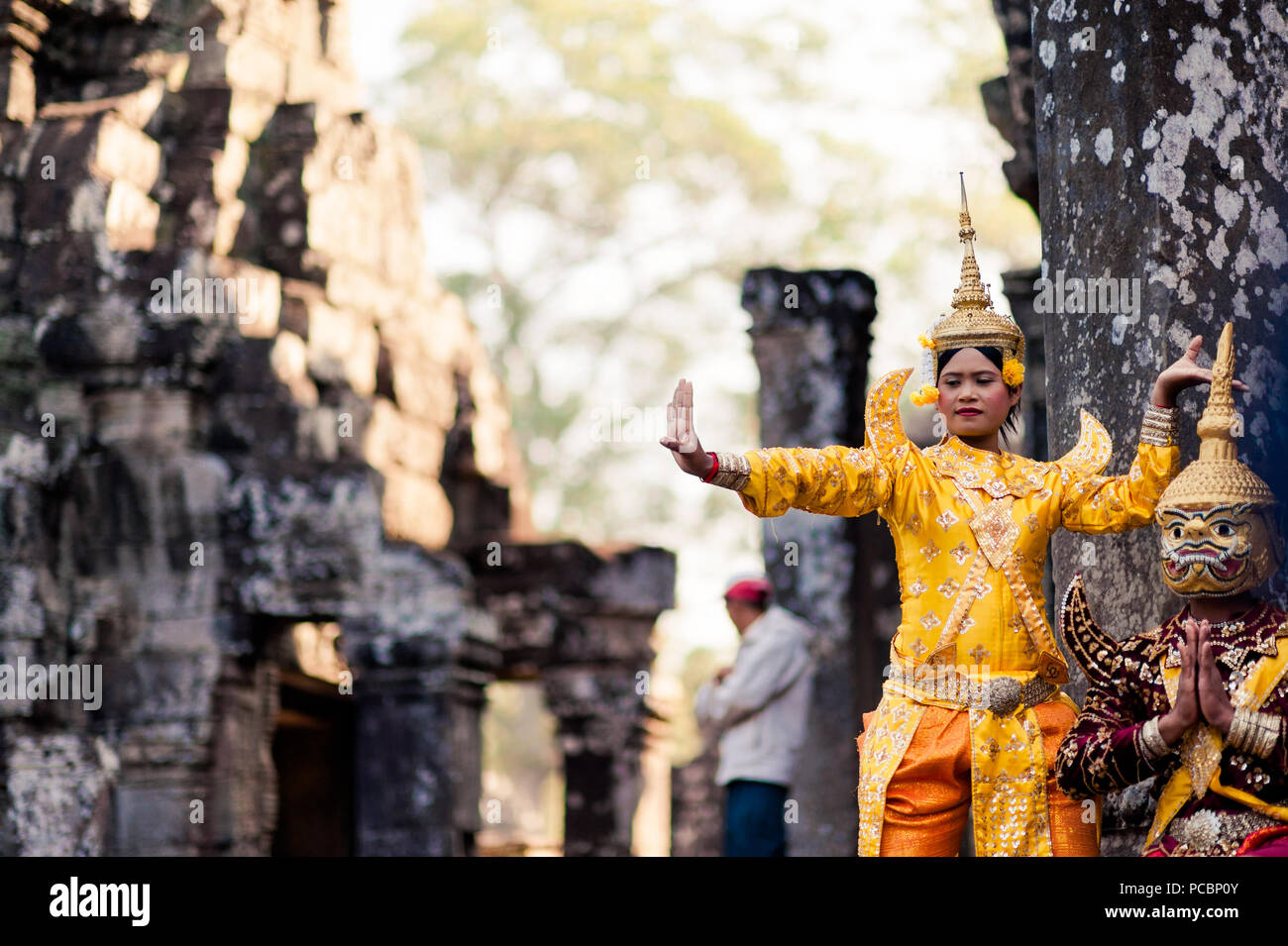 A traditional dance is performed in cultural costume for tourists at the Bayon Temple in the Angkor Wat Park, Siem Reap, Cambodia, South East Asia Stock Photo
