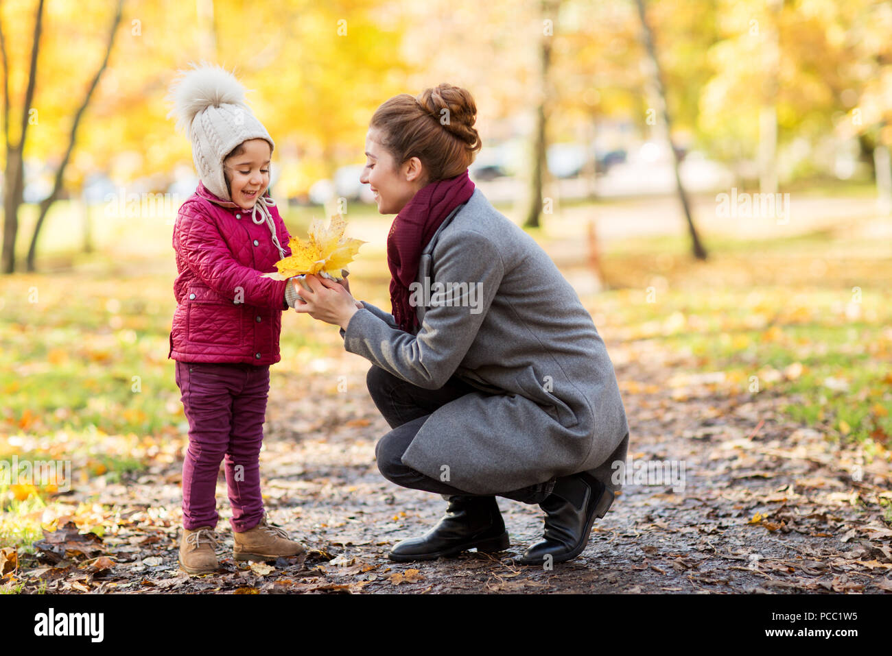 happy family with autumn leaves at park Stock Photo - Alamy