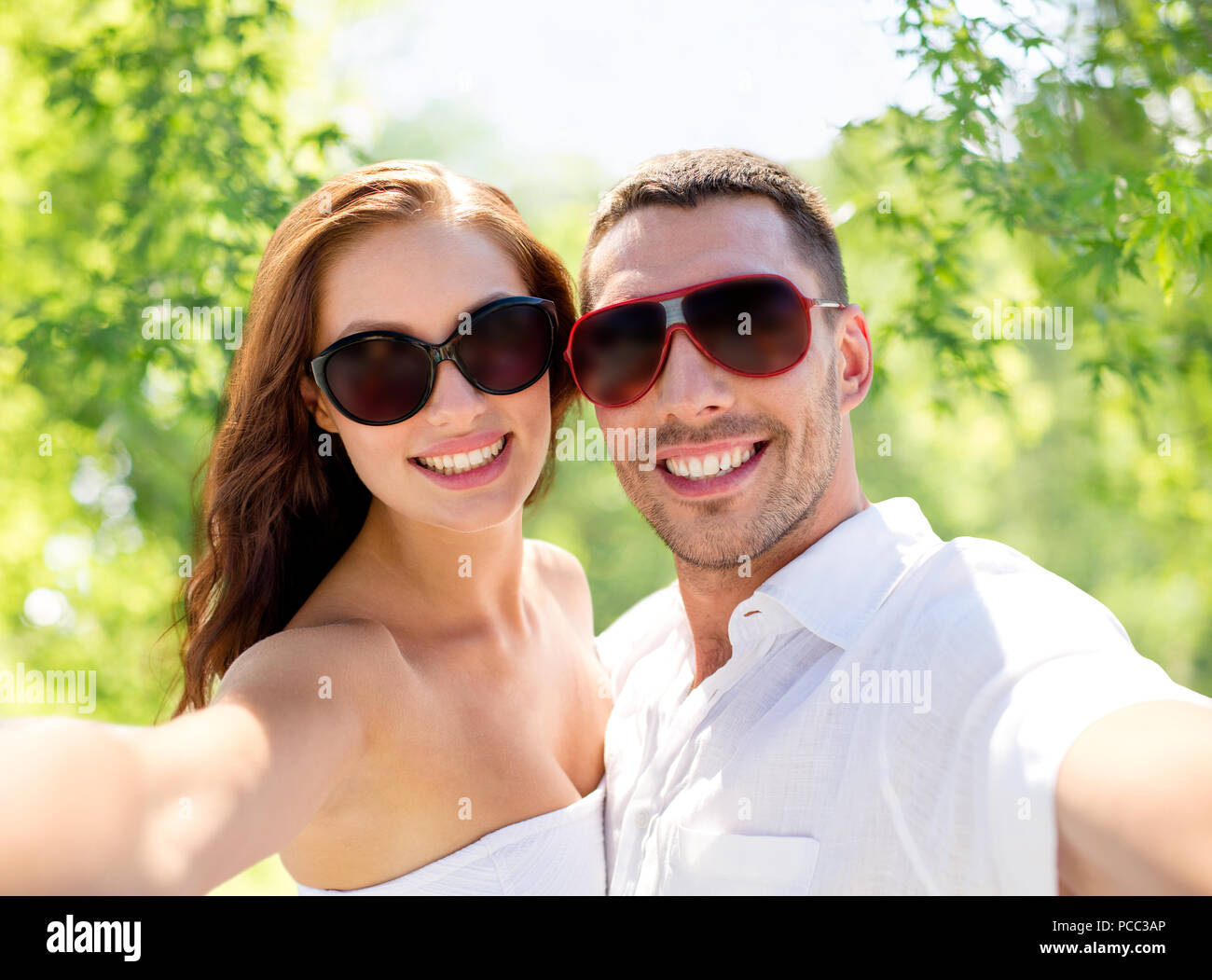 smiling couple wearing sunglasses making selfie Stock Photo