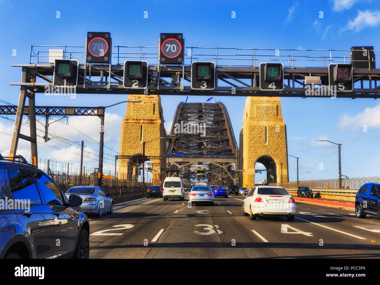 Commuting motor traffic entering Sydney Harbour bridge escaping from the city after business day on multi lane Warringah freeway heading north through Stock Photo
