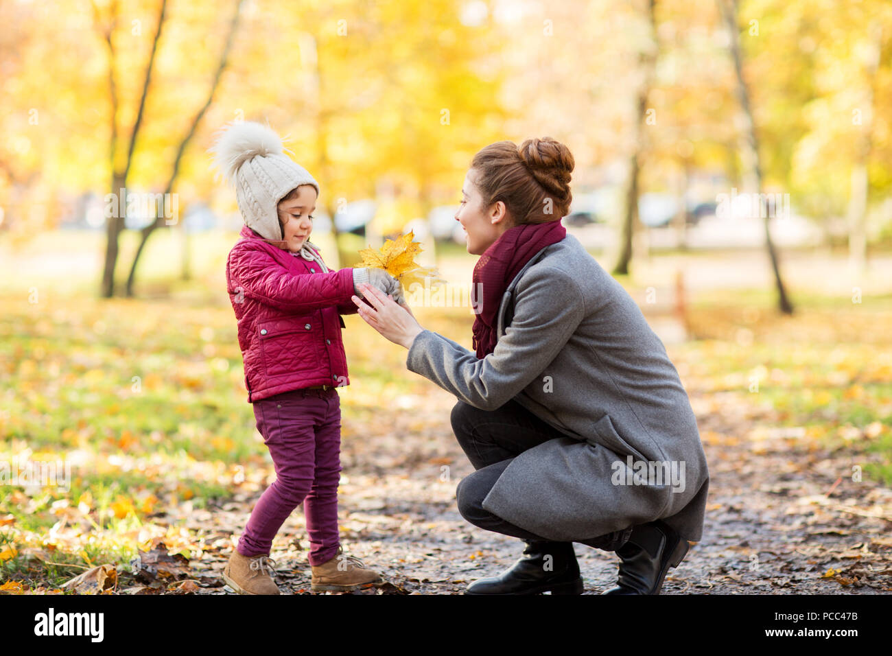 happy family with autumn leaves at park Stock Photo - Alamy