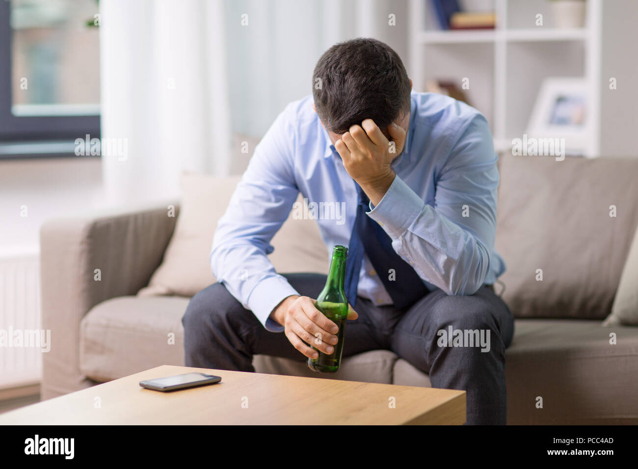 male alcoholic drinking beer at home Stock Photo