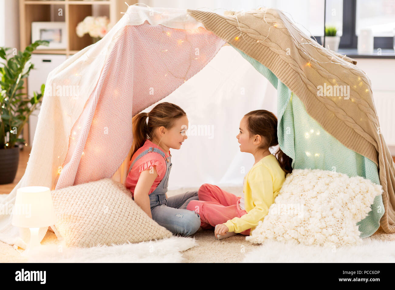little girls talking in kids tent at home Stock Photo
