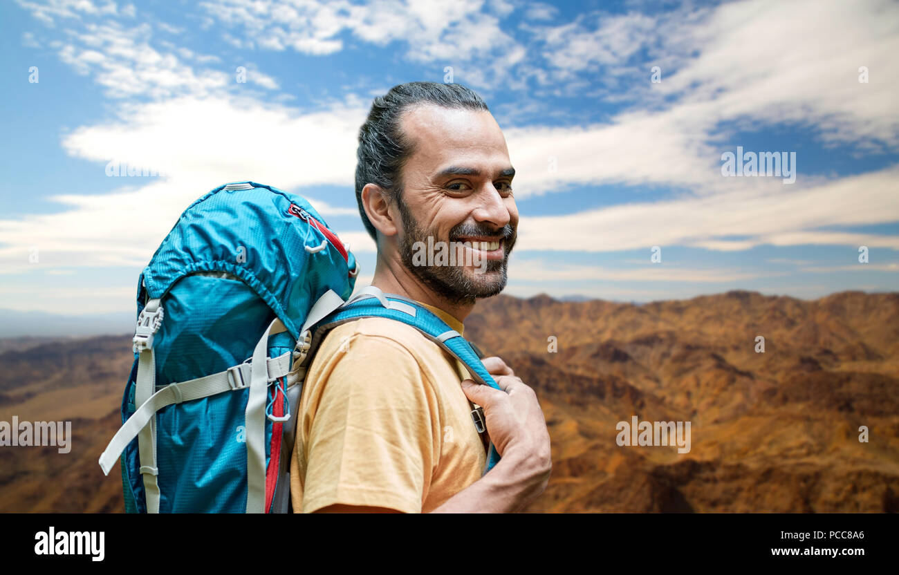 smiling man with backpack over grand canyon hills Stock Photo - Alamy