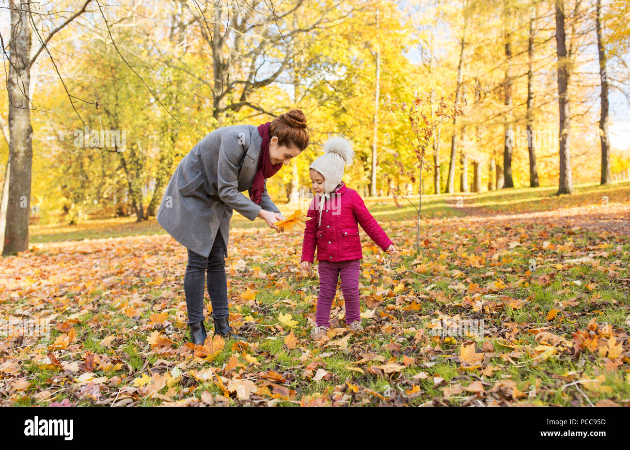 happy family with autumn leaves at park Stock Photo - Alamy