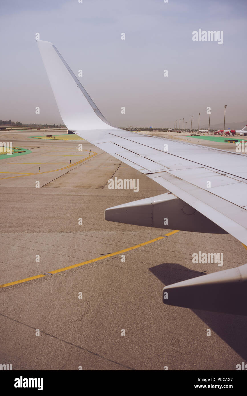 Wing of an aircraft open trailing edge flaps during landing. Airport ...