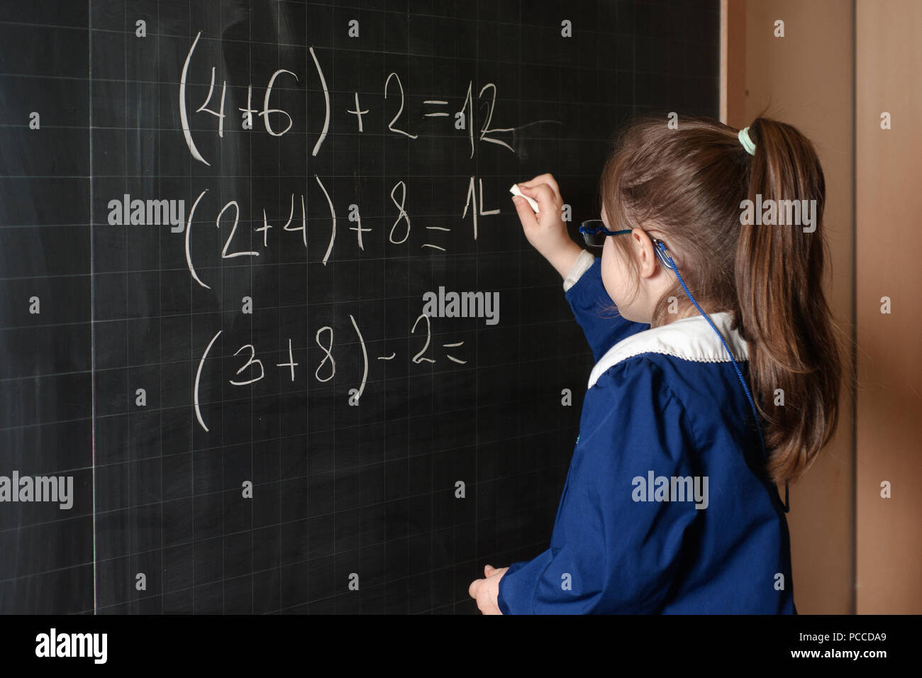 Italian elementary school girl first-grader solve mathematics Stock Photo