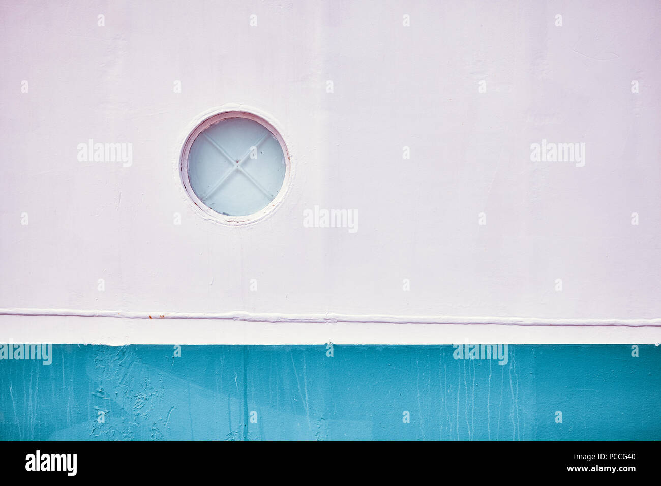 Retro toned close up picture of an old ship side with one porthole. Stock Photo