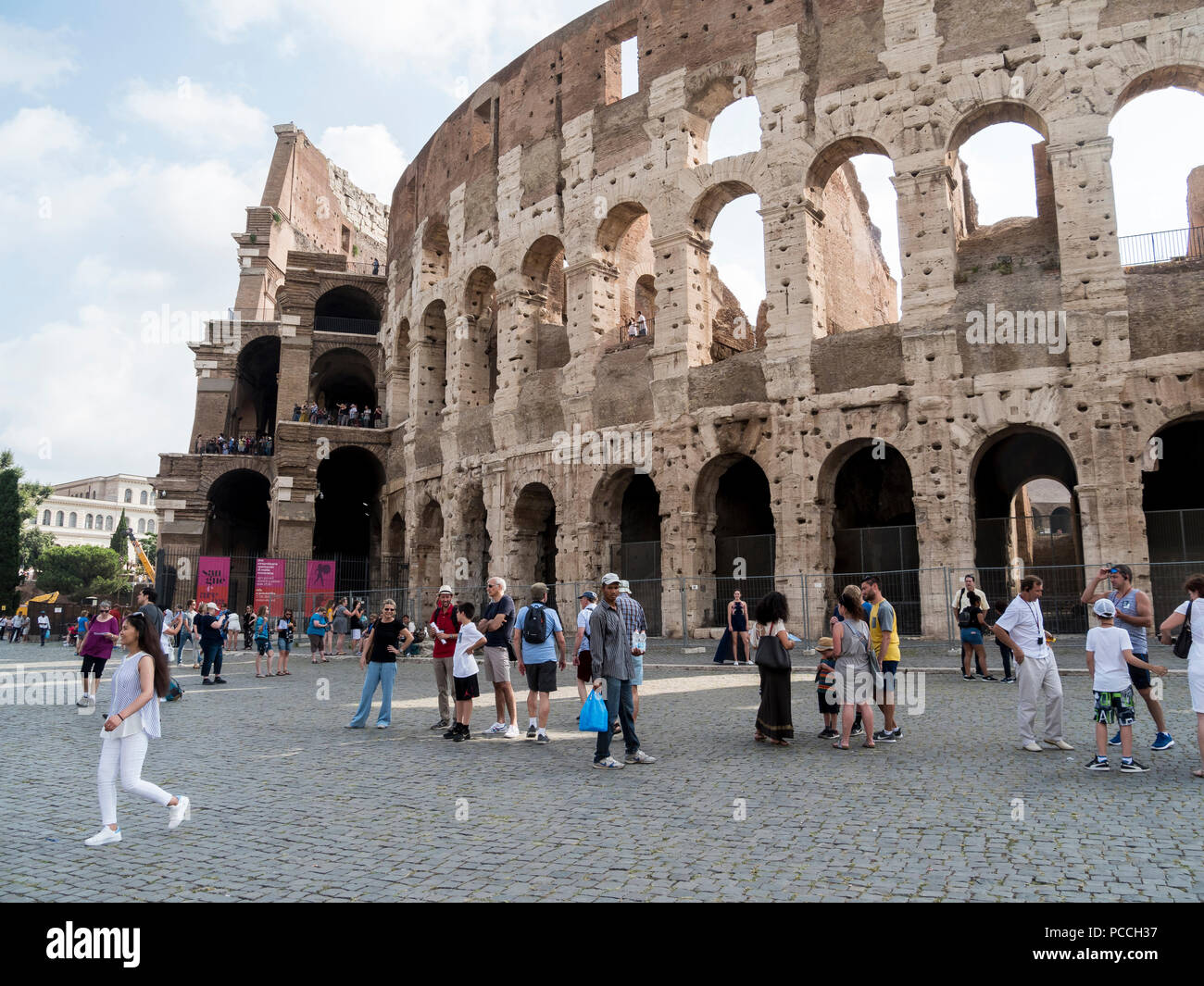 People walking around the walls of the Colosseum, Rome, Italy Stock Photo