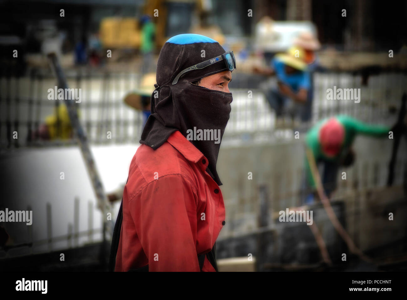 Thailand construction worker wearing heat protection head cover and face mask Stock Photo