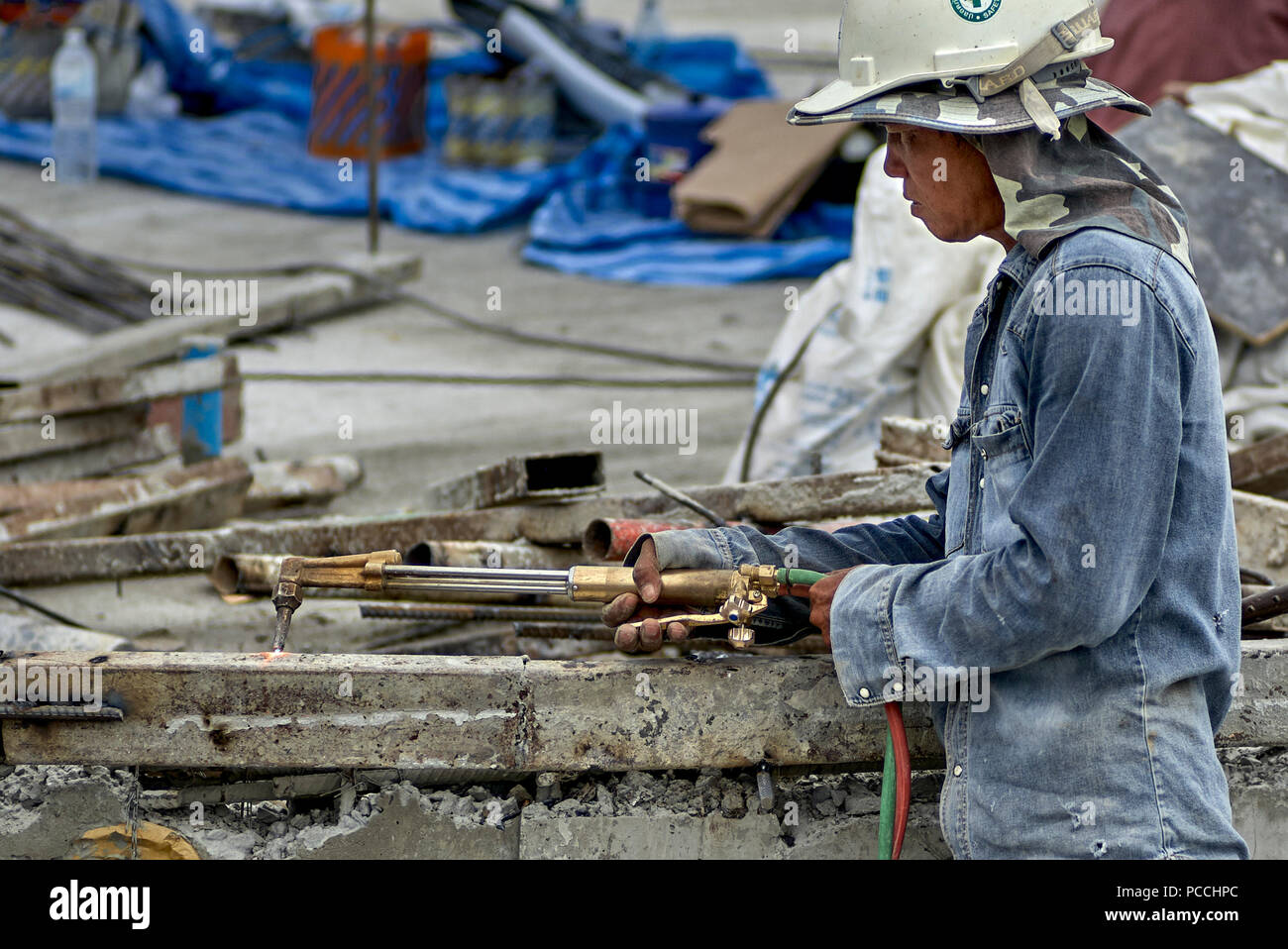 Builder using oxy acetylene torch on a construction site. Thailand Southeast Asia Stock Photo