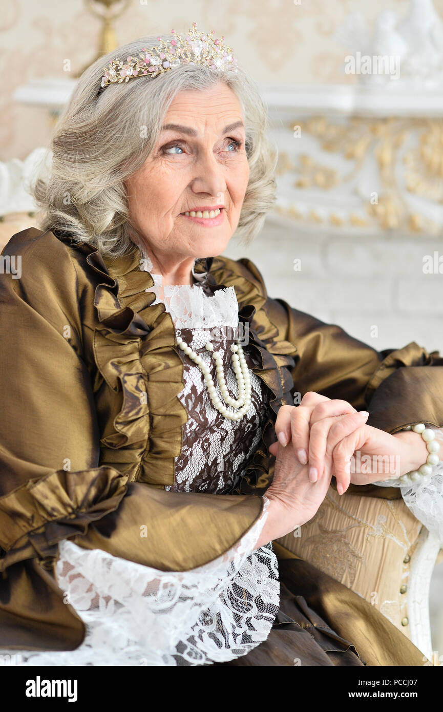 An old woman sitting on a chair vintage hi-res stock photography and ...