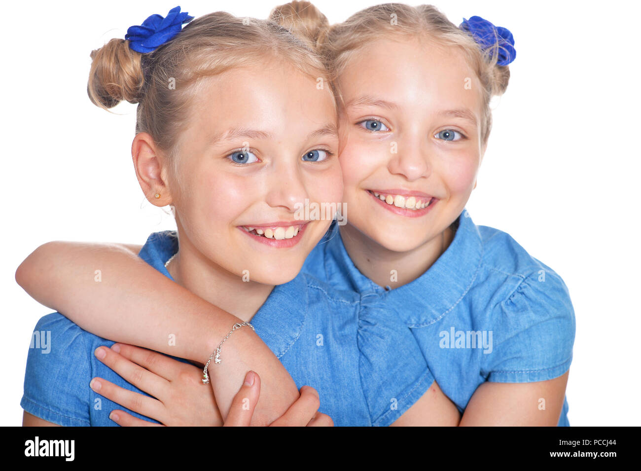 two adorable twin sisters Stock Photo. two little girls in white dresses wi...
