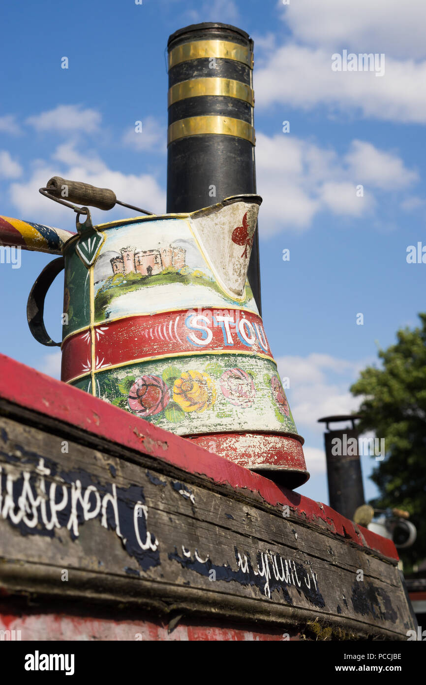 Traditional close up vintage British canal boat section in summer sunshine, Black Country Museum UK. Narrowboat art, painted water jug roses & castles. Stock Photo
