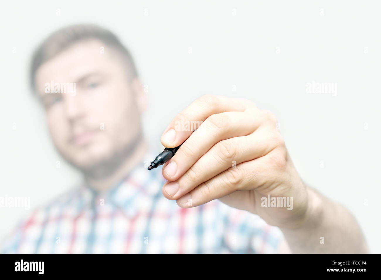 Template - young man draws or write a with marker on the glass wall or screen Stock Photo