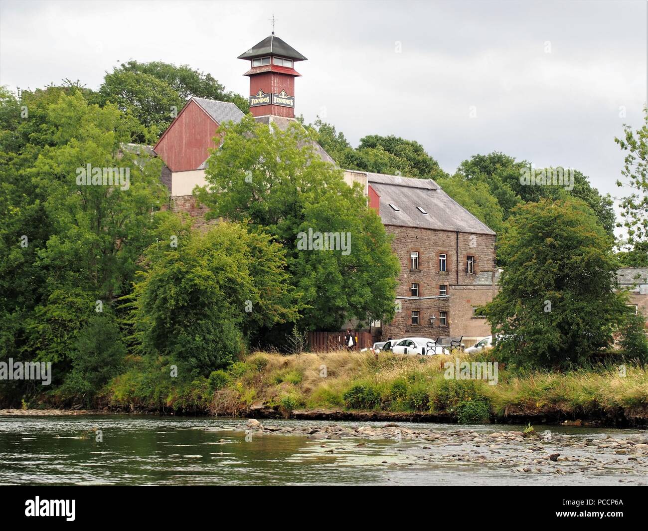 The Buildings of Jennings Brewery from across the River Derwent, Cockermouth, Cumbria, United Kingdom Stock Photo