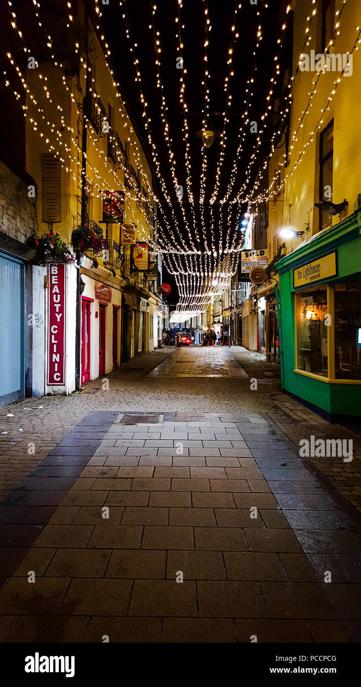 Night street in downtown Galway shining with lights all night long with ...