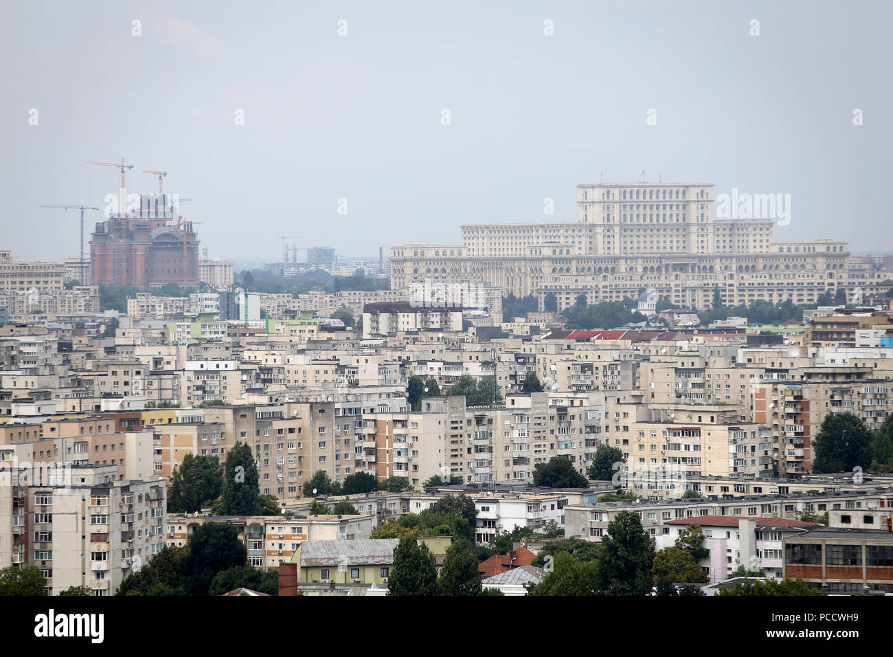 BUCHAREST, ROMANIA - July 31, 2018: Bucharest seen from a high point, with the Palace of Parliament building in the background next to the new cathedr Stock Photo