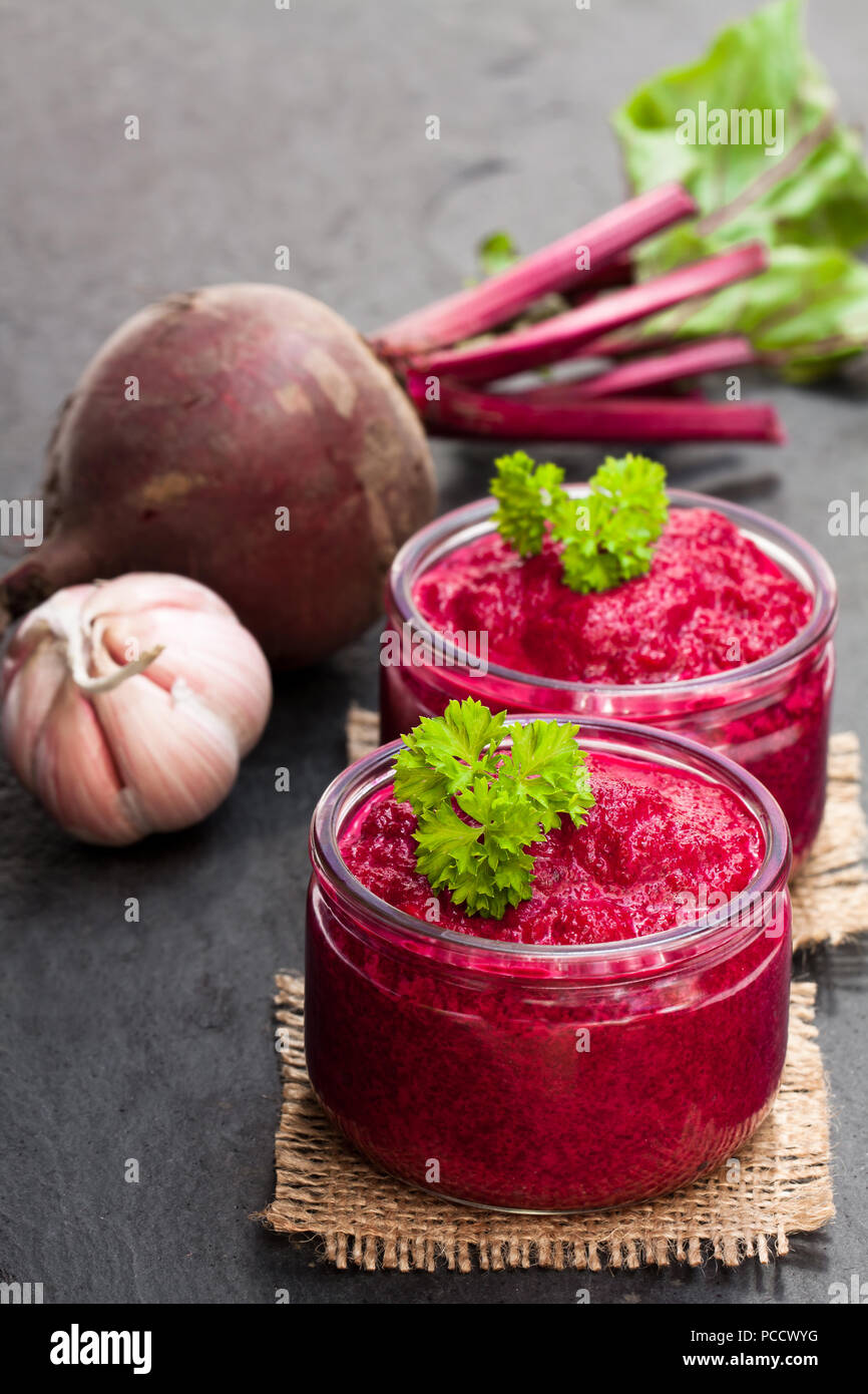 Beetroot puree in glass jars on black stone background Stock Photo - Alamy