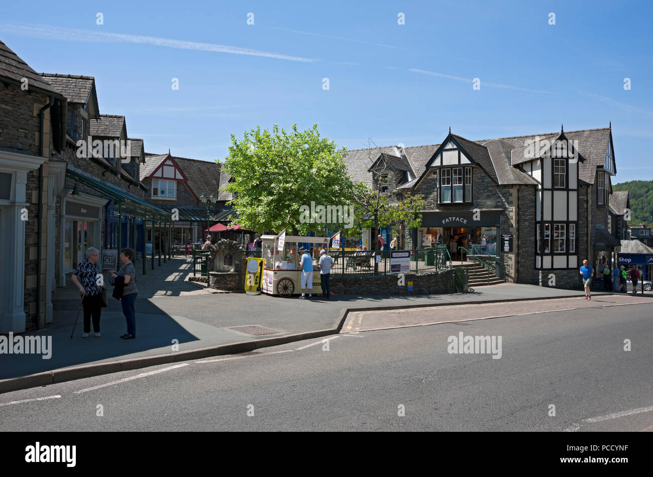 People tourists visitors in the town centre in summer Ambleside Cumbria England UK United Kingdom GB Great Britain Stock Photo