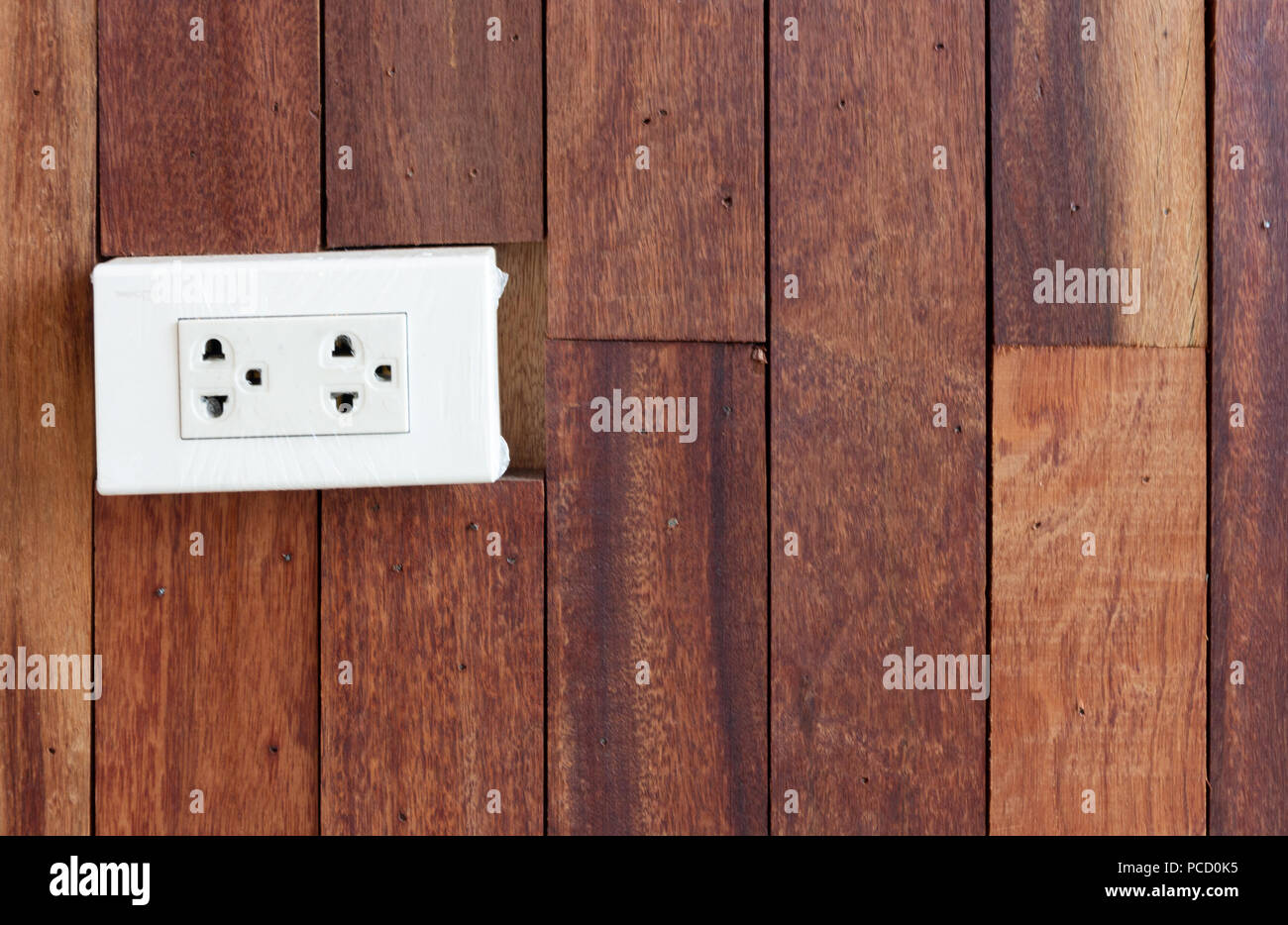 White Electrical Outlet On Wood Texture Wall Home Interior