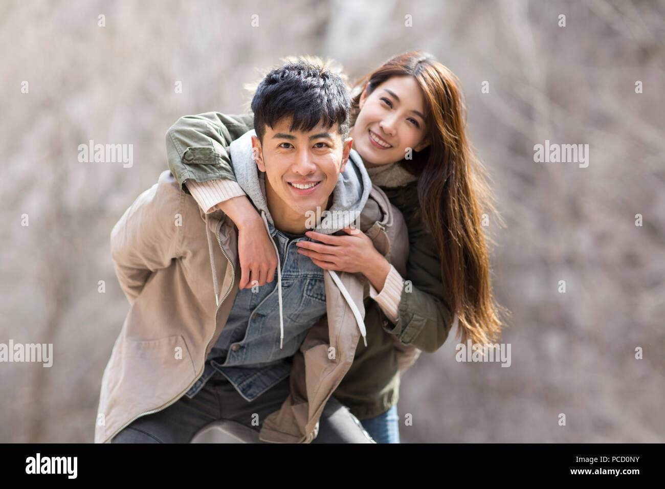 Portrait of happy young Chinese couple outdoors in winter Stock Photo
