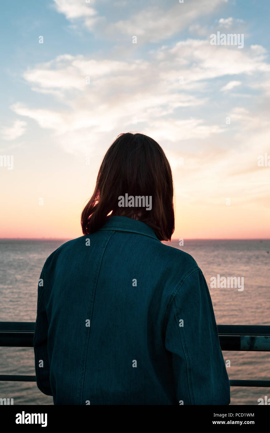 Beautiful young woman watching sunrise hi-res stock photography and ...