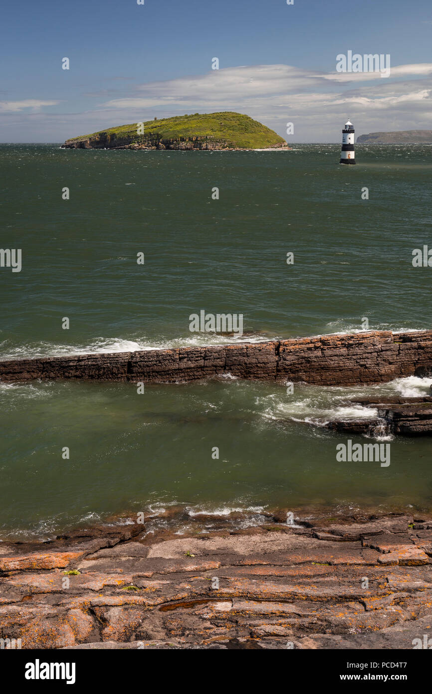 Lighthouse at Penmon Point, Anglesey, North Wales with Puffin Island in the background Stock Photo
