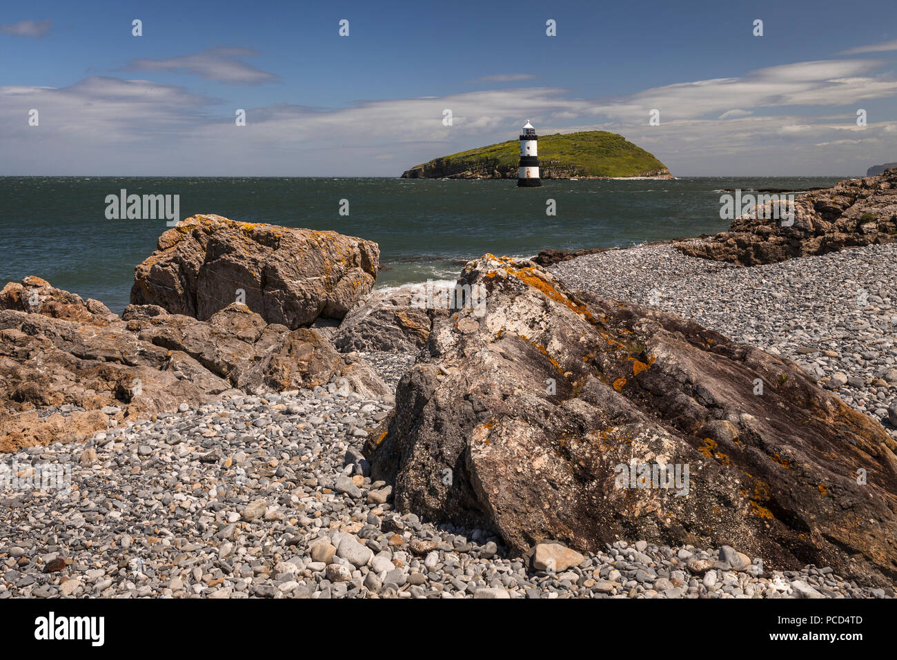 Lighthouse at Penmon Point, Anglesey, North Wales with Puffin Island in the background Stock Photo