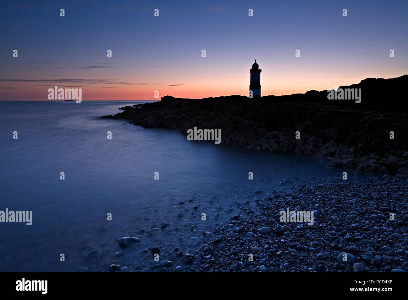 Lighthouse at Penmon Point at dawn, Anglesey, North Wales Stock Photo
