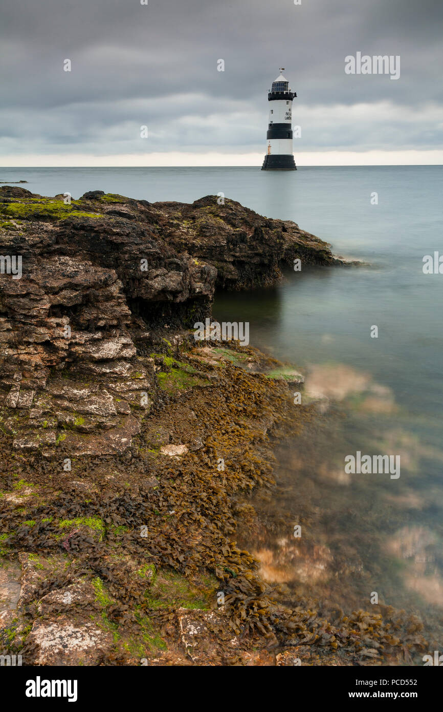 Lighthouse at Penmon Point under clouds, Anglesey, North Wales Stock Photo