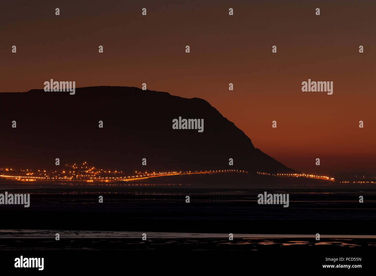 The headland of Penmaenmawr at dusk on the North Wales coast Stock Photo